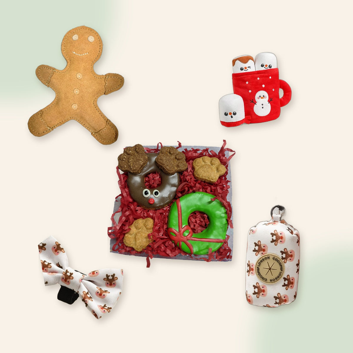 Woof Christmas Gift Box flat lay: gingerbread toy, hot chocolate toy, reindeer cookies, Ralphie Reindeer bow tie and bag holder