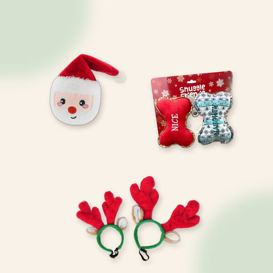Woof Stocking Stuffer flat lay: Santa ball toy, two Christmas plush bones and reindeer antlers headband